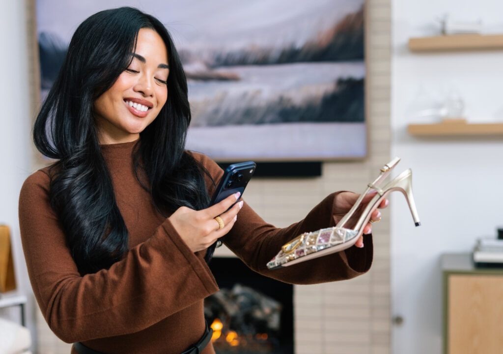 Woman verifying the authenticity of designer heels with Real Authentication